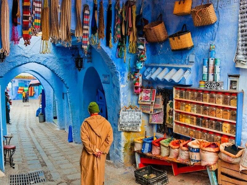 Luxury Sahara Desert Camp showing traditional tents and a camel trek at sunset across the Erg Chebbi dunes, connecting the experience to the grand Imperial Cities tour