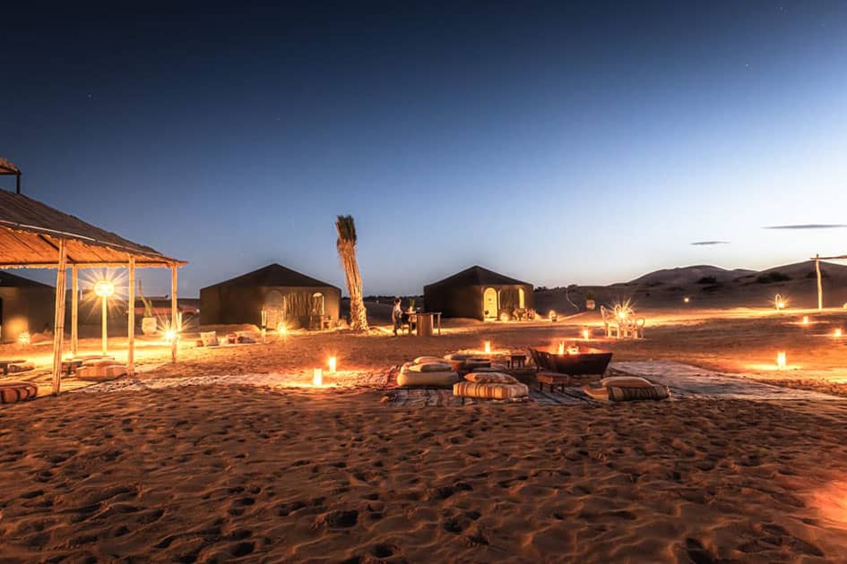 Madu Premium Camp in Erg Chebbi lit by lanterns after dark