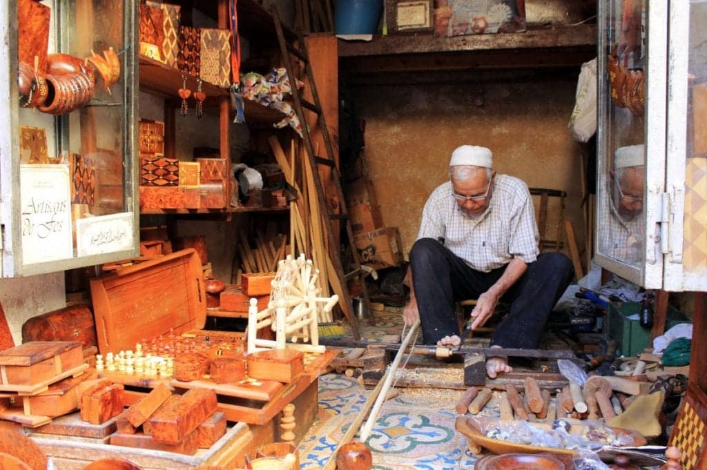 Moroccan artisan crafting traditional wood art, showcasing the country's rich craft traditions