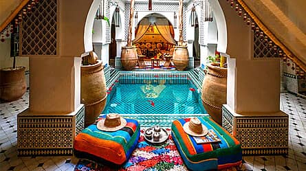 Traditional Moroccan riad courtyard with fountain and zellige tilework