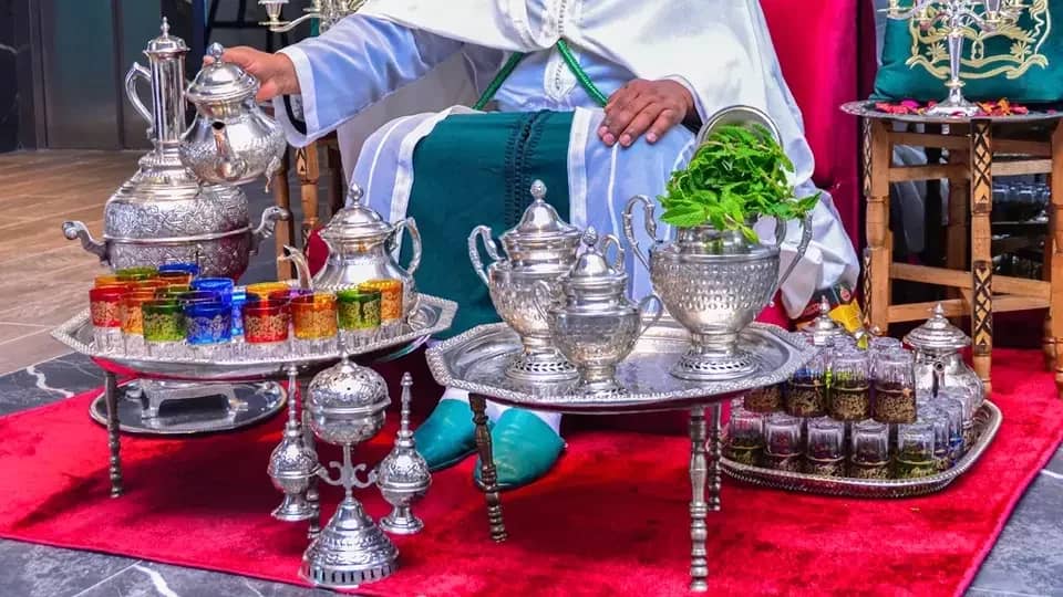 Mint tea poured from a silver teapot