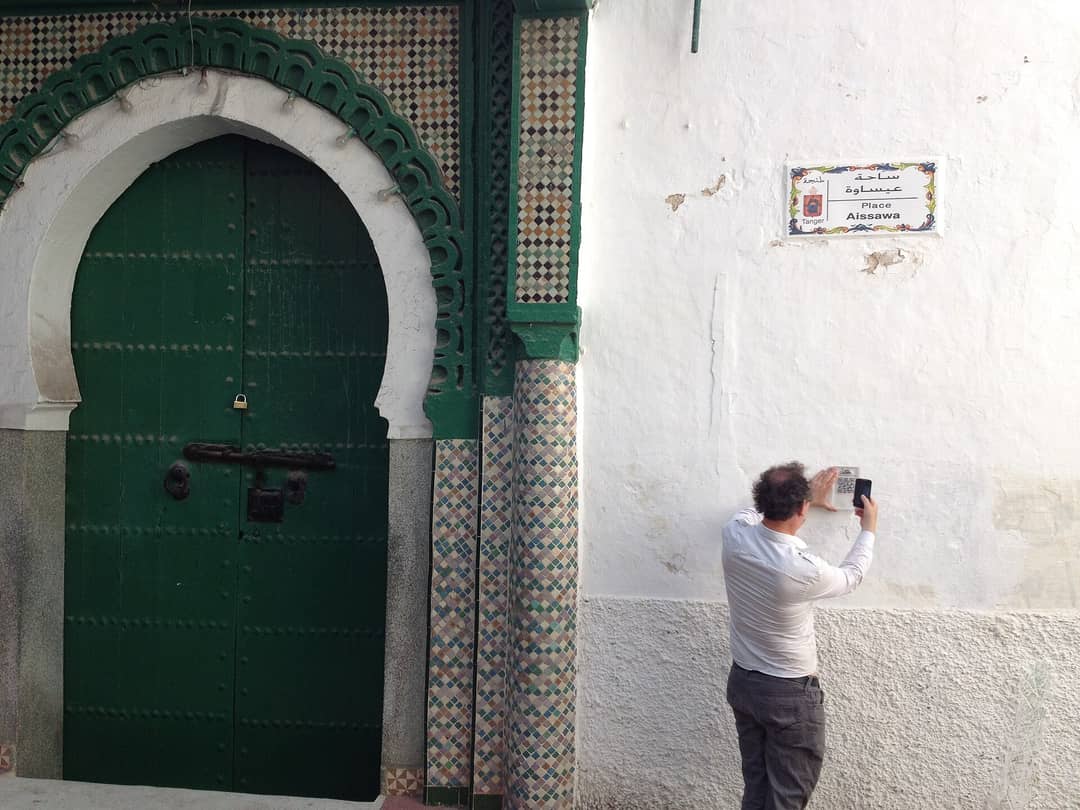 Prayer hall of the Moshe Nahon Synagogue in Tangier with carved stucco walls, wooden ark and hanging silver lamps