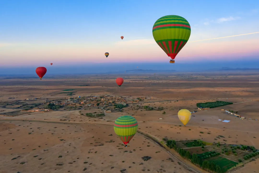 Hot air balloon floating over the Atlas Mountains near Marrakech – luxury Morocco adventure tour experience