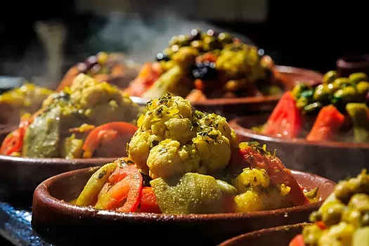 Traditional Moroccan tajine dish with spices – authentic Moroccan cuisine experience on a custom tour