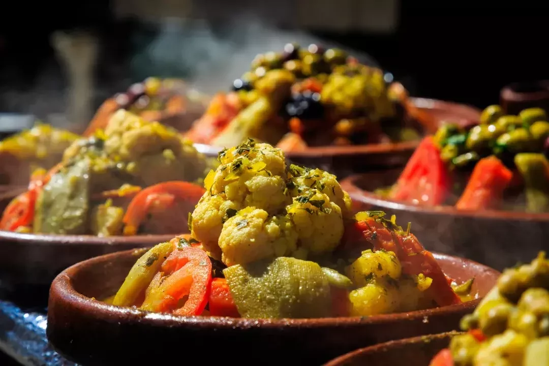 Traditional Moroccan tajine dish with spices – authentic Moroccan cuisine experience on a custom tour
