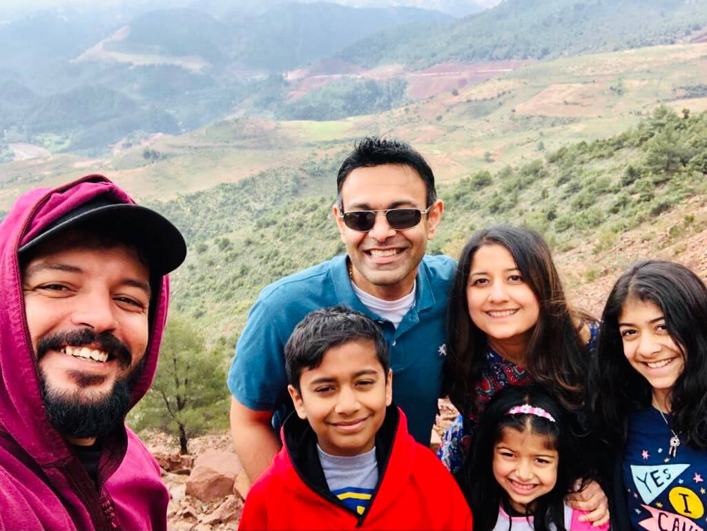 Happy family from the USA enjoying a memorable Gateway2Morocco private tour with their dedicated driver, travelling comfortably between Morocco’s highlights