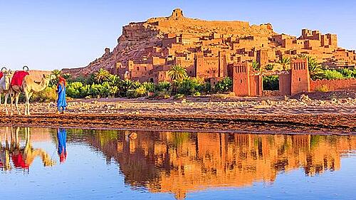 Iconic view of the Ait Benhaddou Kasbah and the dramatic landscape of the Dades Gorge valley on a Morocco custom tour route.